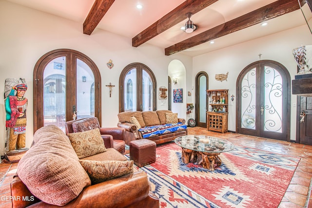 living area with arched walkways, french doors, healthy amount of natural light, recessed lighting, and beam ceiling