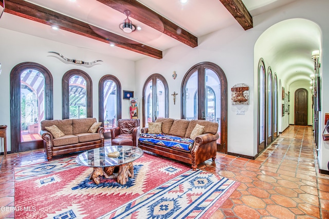 living room featuring arched walkways, beam ceiling, and recessed lighting