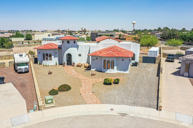 mediterranean / spanish-style house with a tiled roof and stucco siding