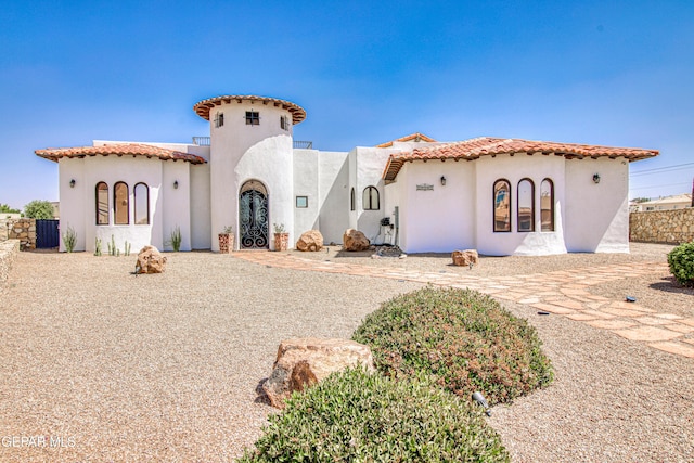 mediterranean / spanish home with stucco siding