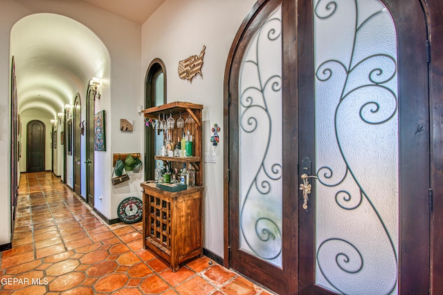 tiled foyer with arched walkways