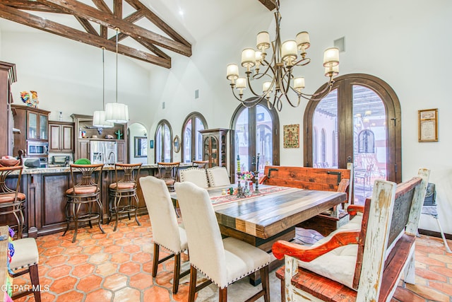 dining room featuring high vaulted ceiling, plenty of natural light, beam ceiling, arched walkways, and a chandelier