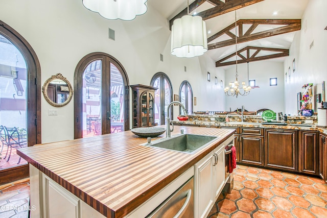 kitchen featuring high vaulted ceiling, a sink, butcher block counters, beamed ceiling, and dishwasher