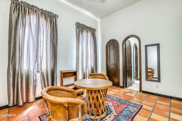 sitting room with light tile patterned flooring and baseboards