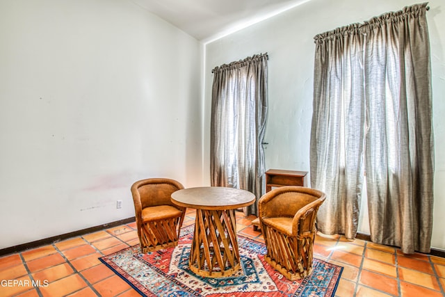 living area with tile patterned floors and baseboards