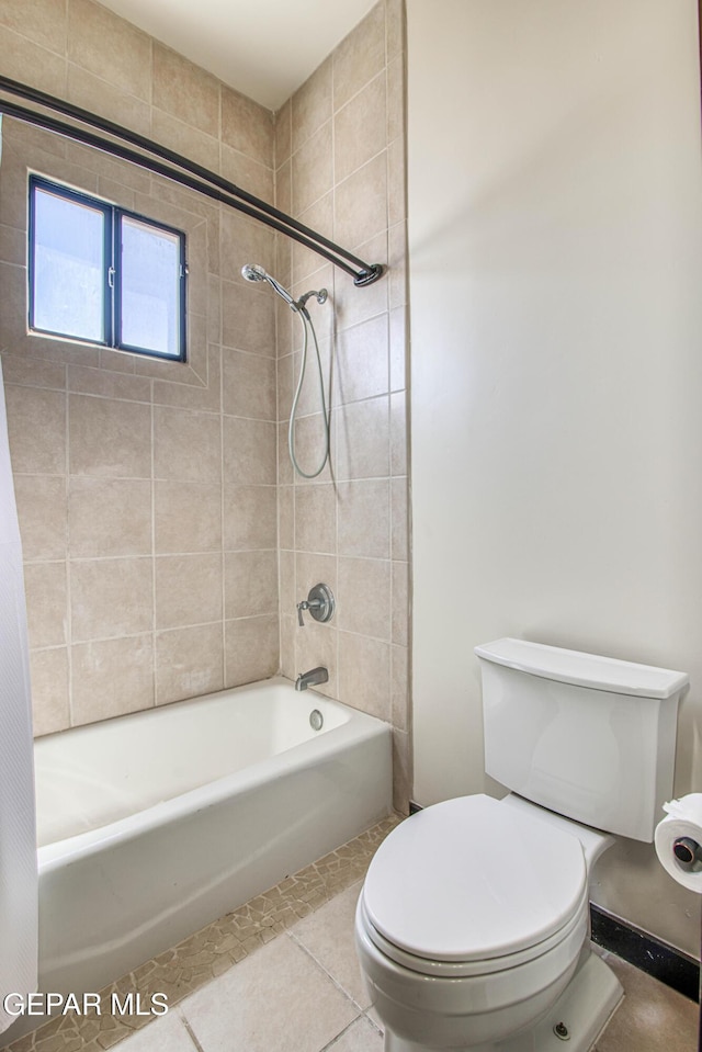 full bath with toilet, bathing tub / shower combination, and tile patterned flooring