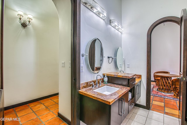 bathroom featuring tile patterned flooring, baseboards, and vanity