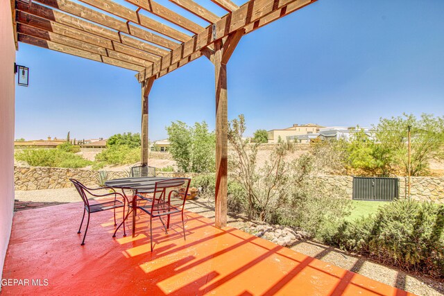 view of patio / terrace featuring outdoor dining space, a pergola, and fence