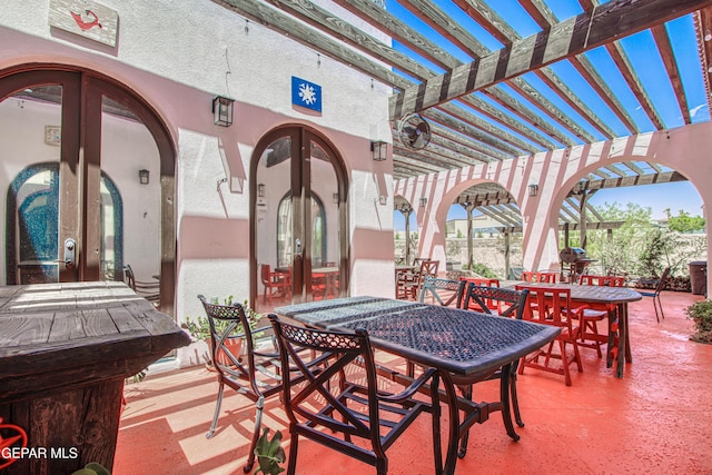 view of patio / terrace with french doors, a pergola, and outdoor dining space