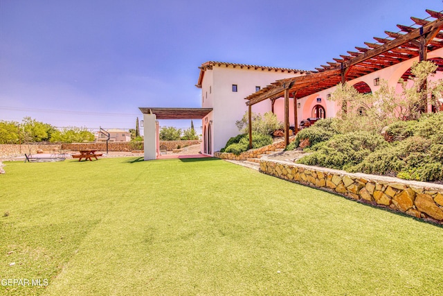 view of grassy yard with a pergola