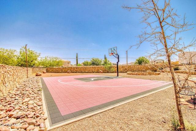 view of sport court with basketball court and fence