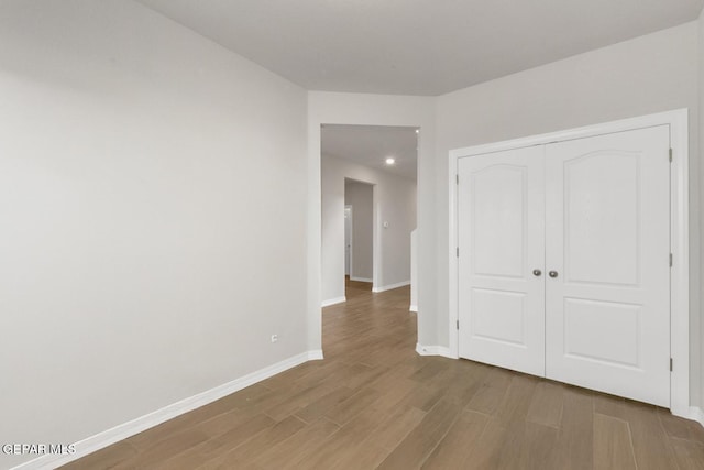 13868 Sky Ranger Ave, El Paso, TX 79928 - unfurnished bedroom featuring wood finished floors, baseboards, a closet, and recessed lighting