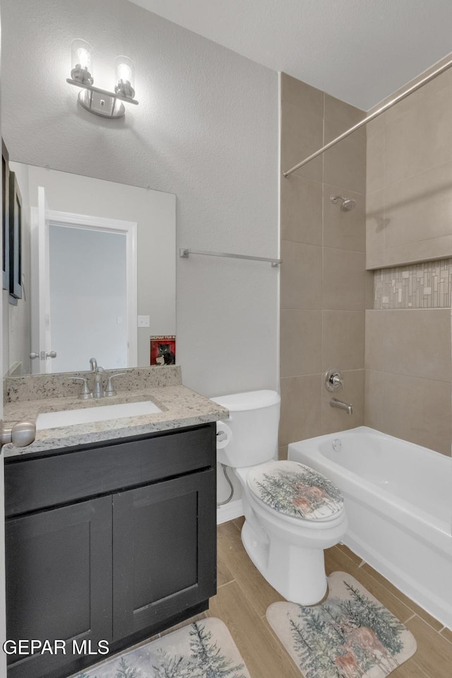 13868 Sky Ranger Ave, El Paso, TX 79928 - full bathroom with tub / shower combination, wood finished floors, toilet, and vanity