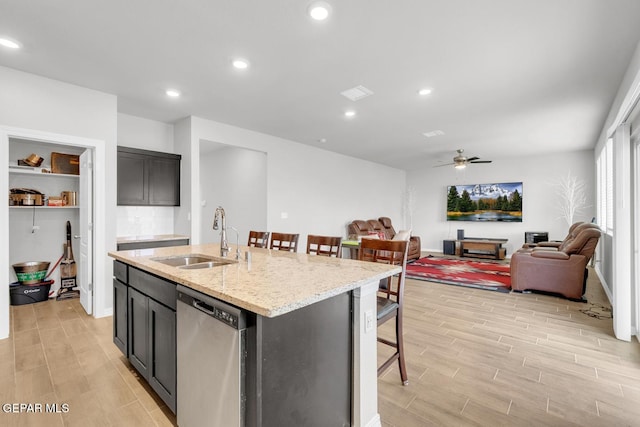 13868 Sky Ranger Ave, El Paso, TX 79928 - kitchen featuring stainless steel dishwasher, a sink, light wood-style flooring, open floor plan, and ceiling fan