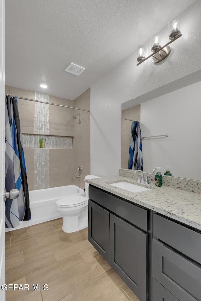 13868 Sky Ranger Ave, El Paso, TX 79928 - full bath with shower / bathtub combination with curtain, toilet, vanity, wood finished floors, and a textured ceiling