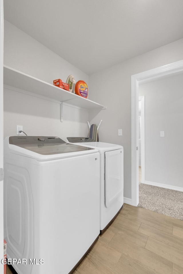 13868 Sky Ranger Ave, El Paso, TX 79928 - clothes washing area featuring washing machine and dryer, light wood-style flooring, and baseboards