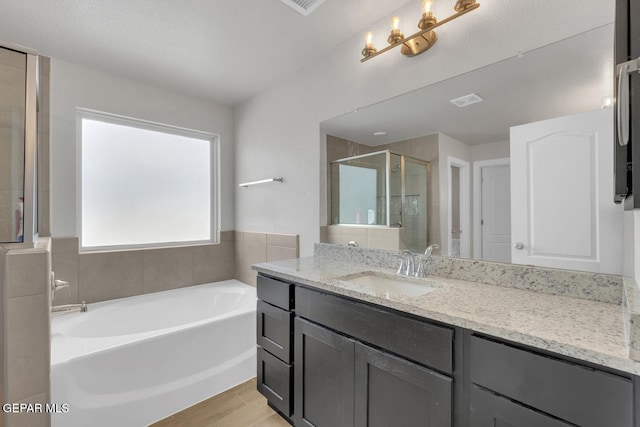 13868 Sky Ranger Ave, El Paso, TX 79928 - full bath featuring a shower stall, a garden tub, and vanity