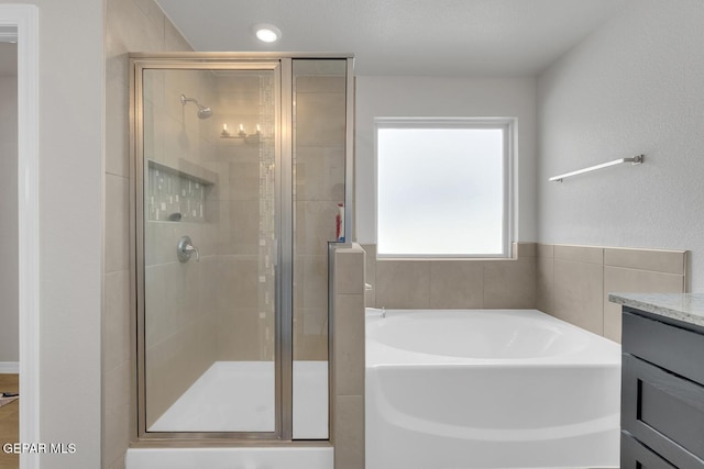 13868 Sky Ranger Ave, El Paso, TX 79928 - bathroom featuring a garden tub, a shower stall, and vanity