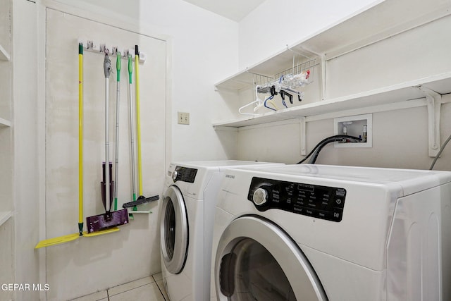 washroom featuring washer and clothes dryer and light tile patterned flooring