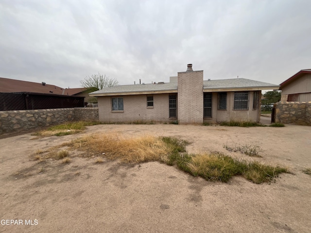 8434 Villanova Dr, El Paso, TX 79907 - rear view of house with a chimney
