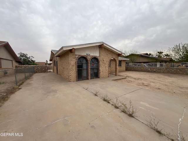 8434 Villanova Dr, El Paso, TX 79907 - view of front of home with concrete driveway, brick siding, and fence