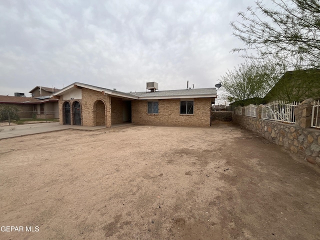 8434 Villanova Dr, El Paso, TX 79907 - rear view of property with fence, brick siding, and concrete driveway