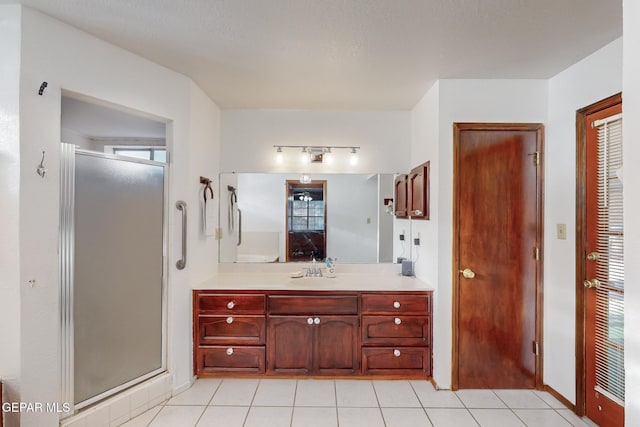 1759 Green Gate Way, El Paso, TX 79936 - full bath featuring a stall shower, tile patterned floors, vanity, rail lighting, and baseboards