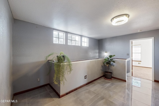 1759 Green Gate Way, El Paso, TX 79936 - empty room featuring baseboards, tile patterned floors, and a textured ceiling