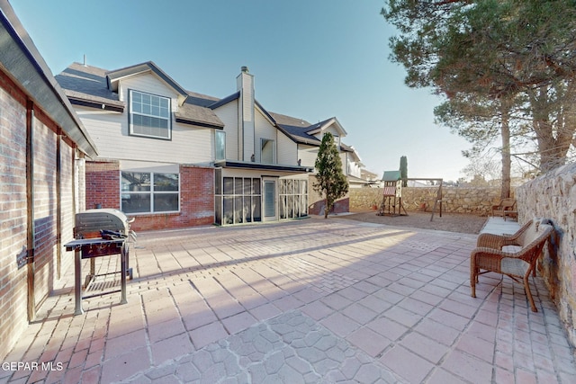 1759 Green Gate Way, El Paso, TX 79936 - view of patio featuring grilling area, a fenced backyard, and a playground