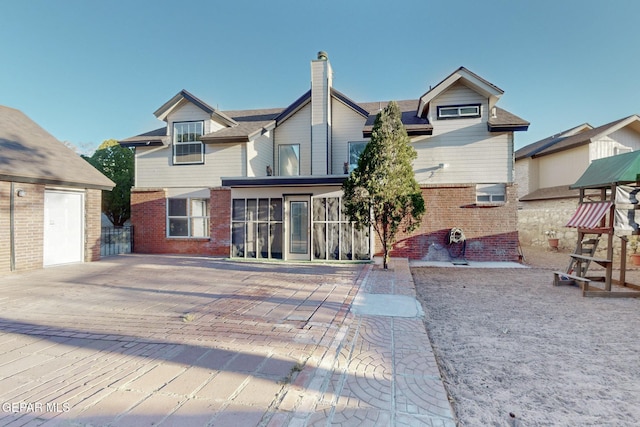 1759 Green Gate Way, El Paso, TX 79936 - rear view of house featuring brick siding and a chimney
