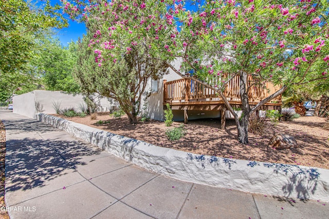 view of front of home featuring a wooden deck and fence