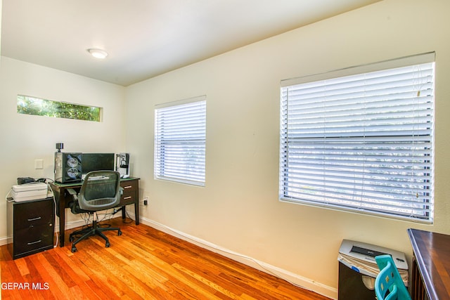 office area with wood finished floors and baseboards