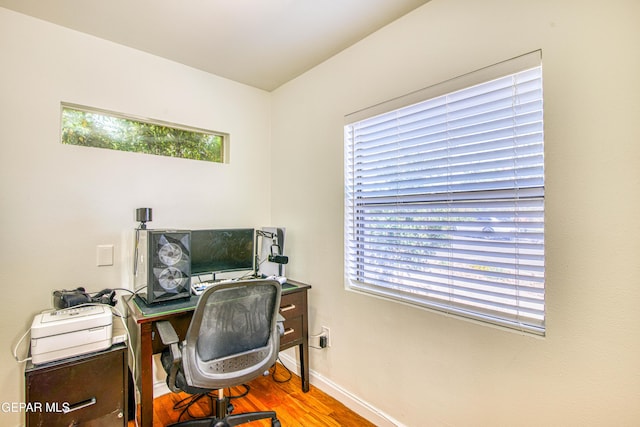 office space featuring baseboards and wood finished floors