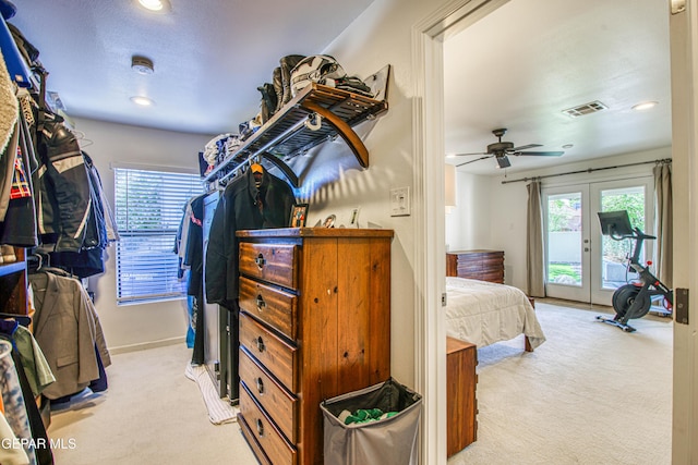 spacious closet with light carpet and a ceiling fan