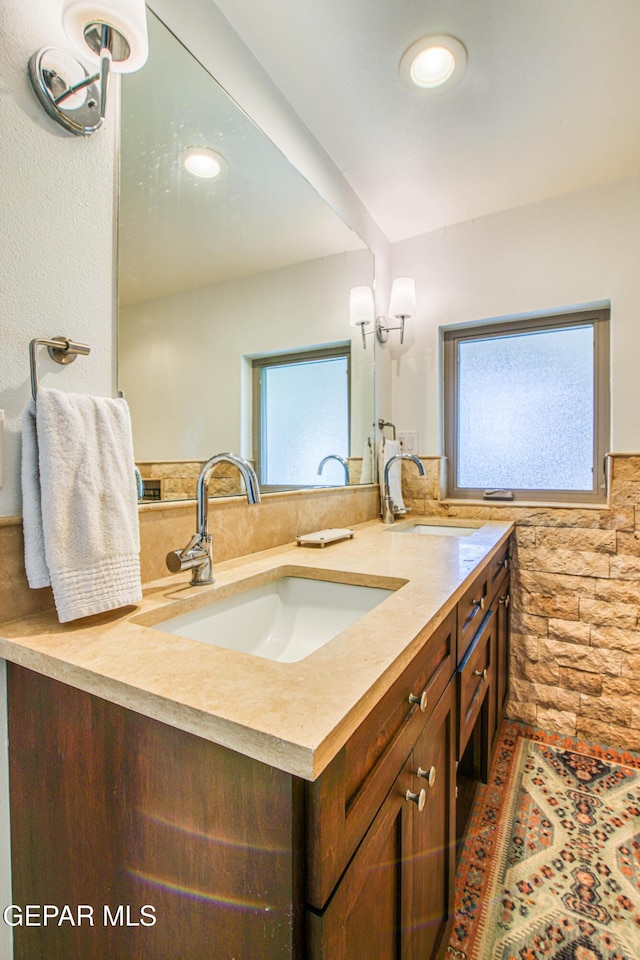 bathroom with healthy amount of natural light, double vanity, and recessed lighting