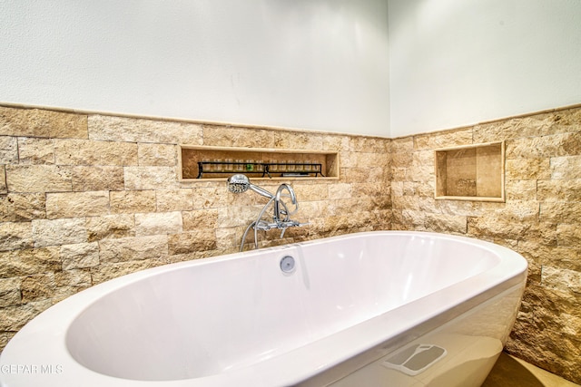 bathroom with a soaking tub