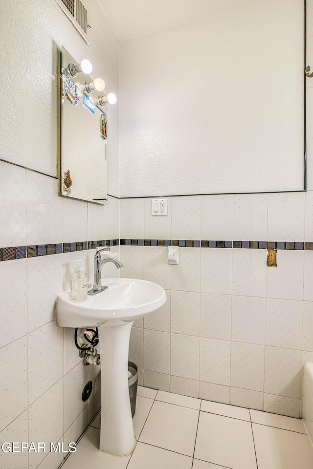 bathroom featuring tile patterned floors and tile walls