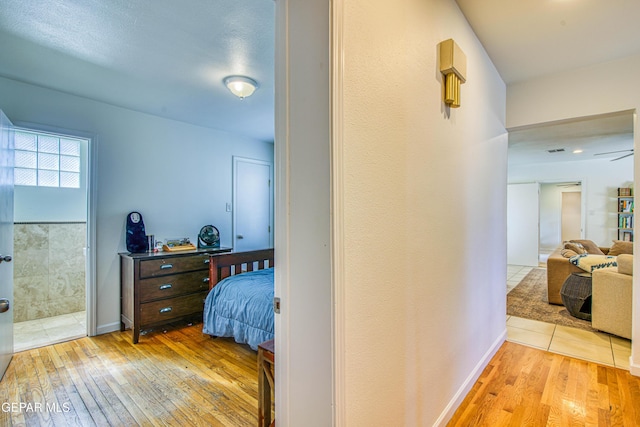 hallway featuring hardwood / wood-style flooring and baseboards