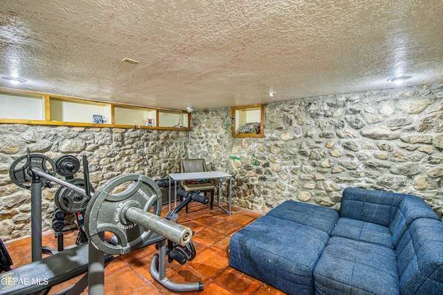 workout room featuring a textured ceiling