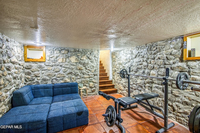 exercise area featuring a textured ceiling
