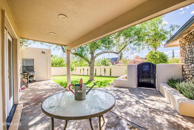 view of patio featuring a gate