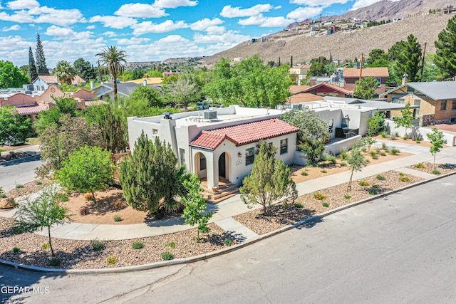 aerial view of residential area featuring a mountainous background