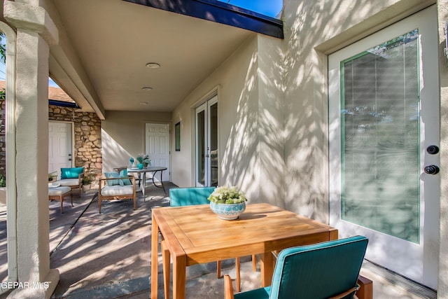 view of patio with outdoor dining area and french doors