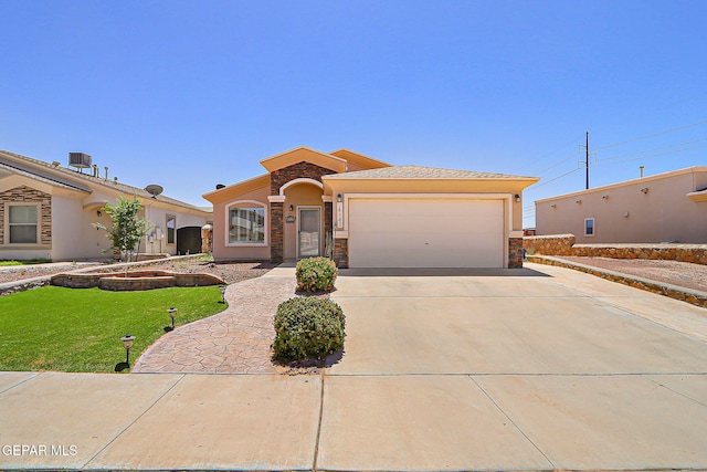14182 John Scagno, El Paso, TX 79938 - mediterranean / spanish home with a garage, stucco siding, stone siding, and driveway