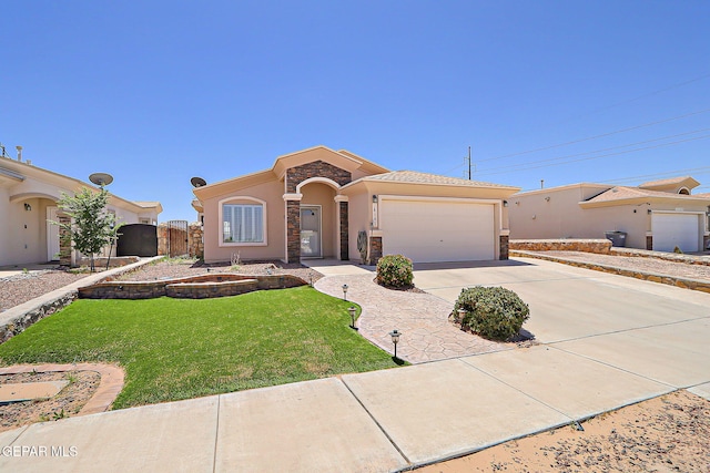 14182 John Scagno, El Paso, TX 79938 - mediterranean / spanish-style home featuring stone siding, concrete driveway, a garage, stucco siding, and a front yard