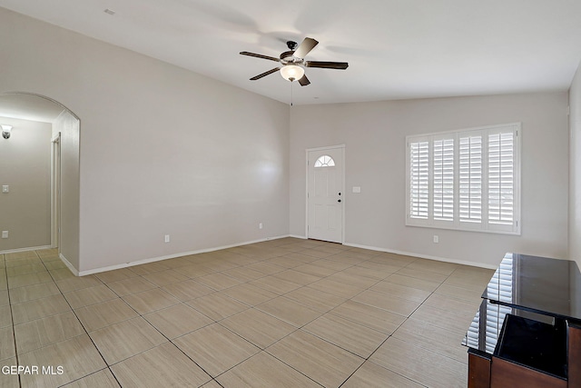 14182 John Scagno, El Paso, TX 79938 - interior space with light tile patterned flooring, baseboards, a ceiling fan, and arched walkways
