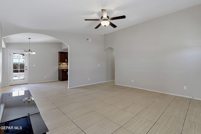14182 John Scagno, El Paso, TX 79938 - unfurnished living room featuring light tile patterned flooring, visible vents, ceiling fan with notable chandelier, and arched walkways