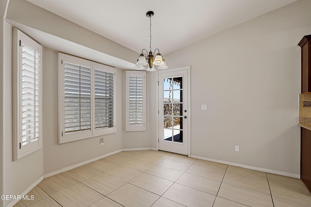 14182 John Scagno, El Paso, TX 79938 - unfurnished dining area with a chandelier, baseboards, and light tile patterned flooring