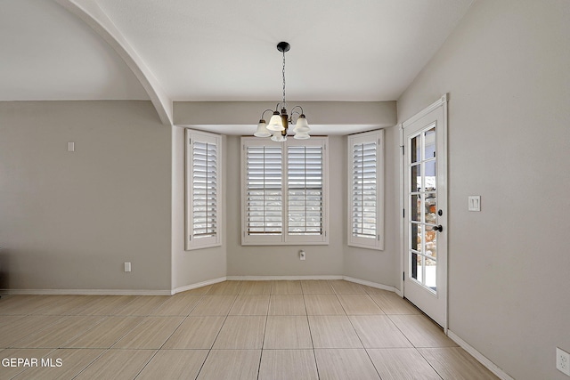 14182 John Scagno, El Paso, TX 79938 - unfurnished dining area featuring a chandelier, baseboards, and tile patterned flooring