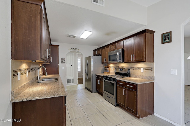14182 John Scagno, El Paso, TX 79938 - kitchen with backsplash, appliances with stainless steel finishes, visible vents, and a sink
